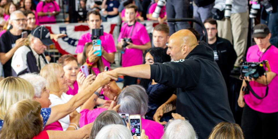 Fetterman shaking hands with people in crowd