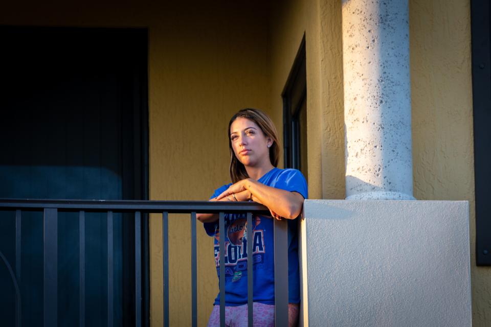 Marietta Diaz, 30,  who works in medical device sales, stands on her balcony in Wellington, Florida, on March 23, 2020, she is in quarantine after testing positive for novel coronavirus (Covid-19). - Diaz has an 8-year-old daughter who starts homeschool next week and shes nervous how it will go. I decided to go to urgent care when I was standing in the OR and I couldnt catch my breath. Watching the news and being someone with anxiety your body can create symptoms. It was a battle in my mind whether is was mental symptoms or viral symptoms.  Diaz has received some backlash from people she was in contact with. The backlash Ive received from people was a breaking point for me. People know its out there everywhere, and people are so quick to point a finger at people that have tested positive. But, people are going out on boats and having small get togethers and they could be asymptomatic carriers, Diaz said. Diaz still has 12-days of mandatory quarantine and finds it hard to pass the time. Its difficult being home alone and not being able to exercise or read a book because my head hurts. (Photo by Zak BENNETT / Zak BENNETT / AFP) (Photo by ZAK BENNETT/Zak BENNETT/AFP via Getty Images)