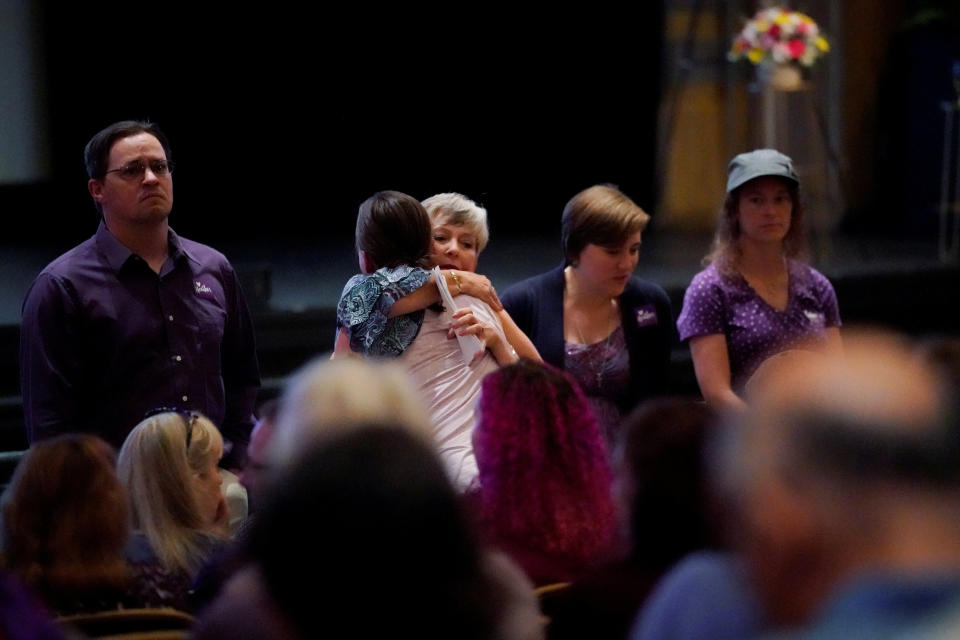 Mourners inside the Paramount Theater wear purple, as Heyer's family had requested. Purple was her favorite color.