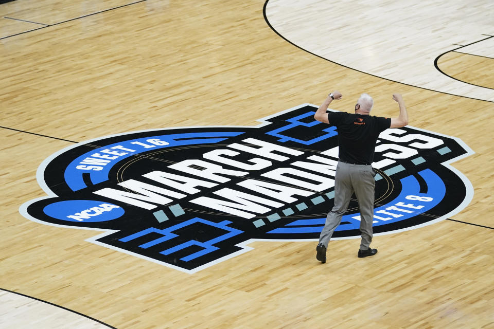 Oregon State head coach Wayne Tinkle celebrates as he walks off the court after a Sweet 16 game against Loyola Chicago in the NCAA men's college basketball tournament at Bankers Life Fieldhouse, Saturday, March 27, 2021, in Indianapolis. Oregon State won 65-58. (AP Photo/Darron Cummings)