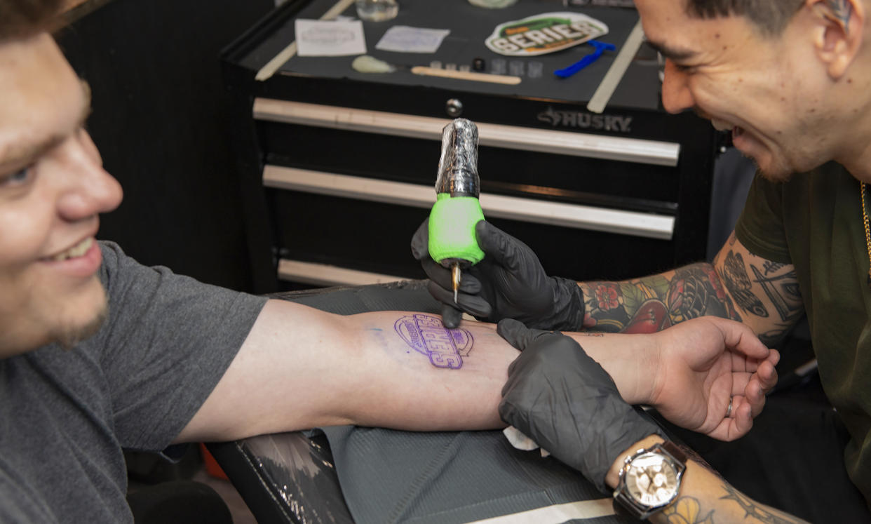 Participant Michael Booker getting a Subway Series tattoo at Bad Apple Tattoo. (Subway)