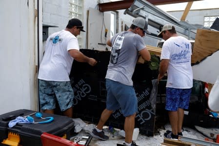 Men work in a devastated house after Hurricane Dorian hit the Abaco Islands in Treasure Cay