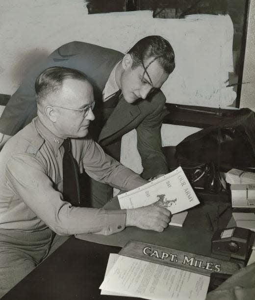 Capt. Frank Miles, left, and son Frank Miles Jr. are shown in the elder Miles' office in Des Moines on Dec. 12, 1941. Frank Miles Jr. had joined the U.S. Army Air Corps on Dec. 8, 1941, the day the U.S. declared war on Japan after the Dec. 7 attack on Pearl Harbor.