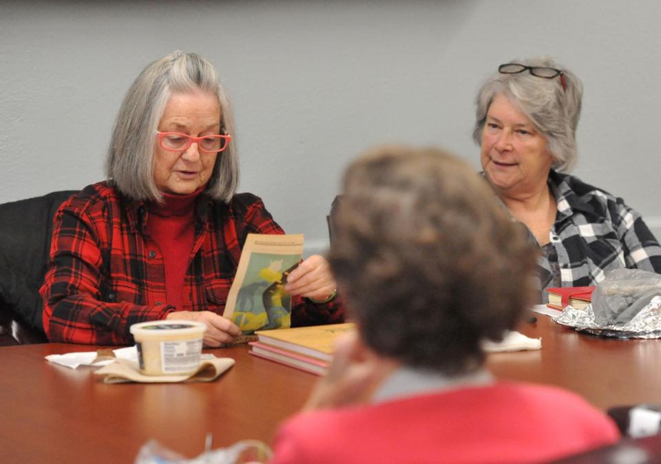 Nanci Palmer, left, reads a poem during the Weymouth Elder Services' writers workshop at the Weymouth Senior Center, Wednesday, Dec. 7, 2022.