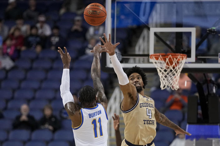 Pittsburgh guard Jamarius Burton shoots over Georgia Tech forward Javon Franklin during the first half of an NCAA college basketball game at the Atlantic Coast Conference Tournament, Wednesday, March 8, 2023, in Greensboro, N.C. (AP Photo/Chris Carlson)