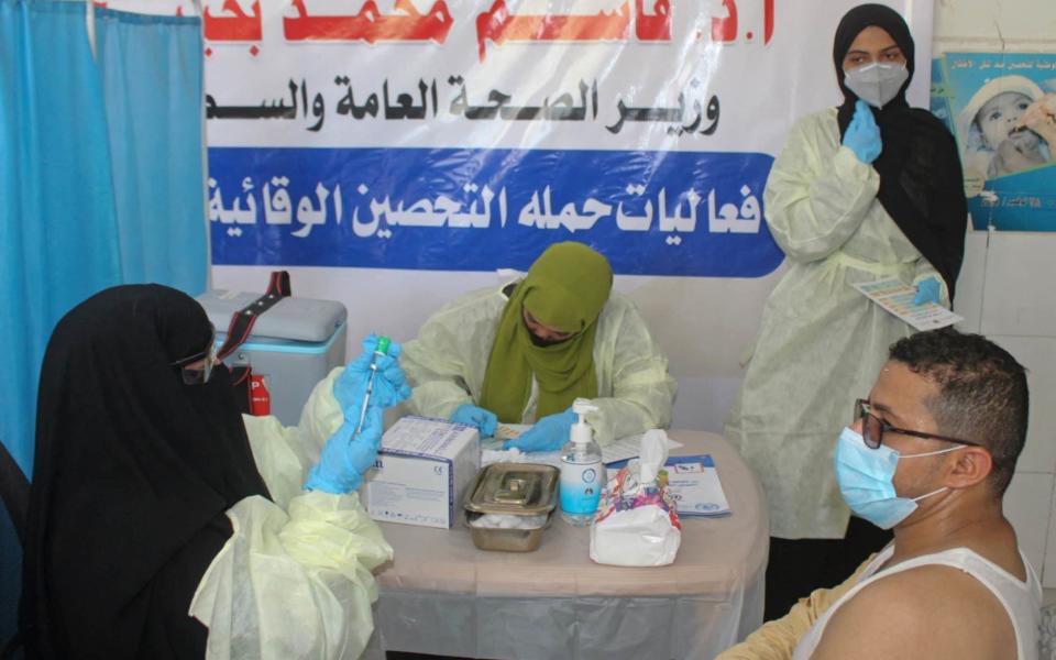 A Yemeni medic prepares a dose of the AstraZeneca COVID-19 vaccine at a vaccination centre in al-Maala district of the southern city of Aden - SALEH OBAIDI/AFP