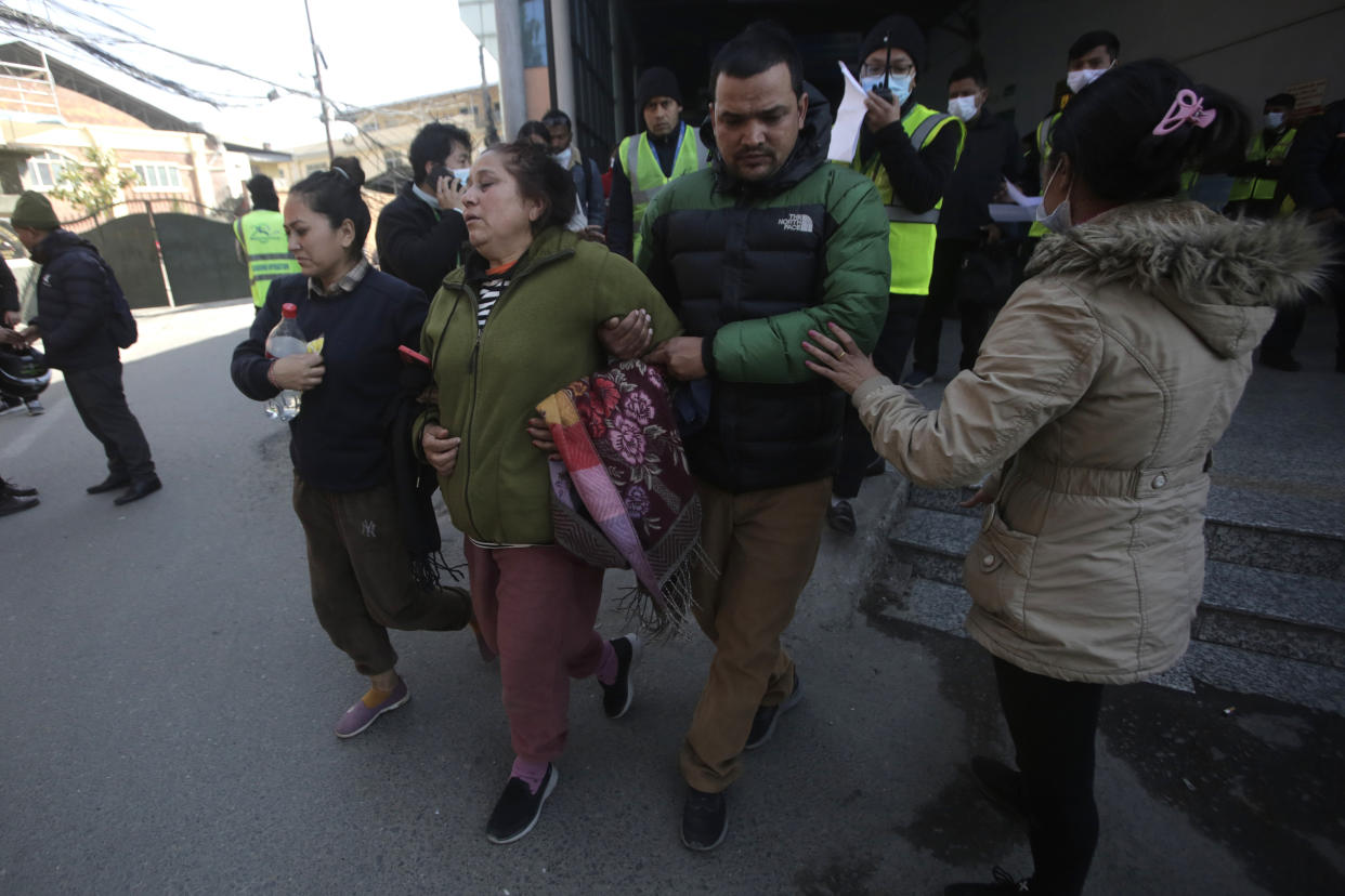 Relatives of a crashed passenger plane wail at Katmandhu airport, Nepal, Sunday, Jan.15, 2023. A passenger plane with 72 people on board has crashed near Pokhara International Airport in Nepal, the daily newspaper Kathmandu Post reports. The plane was carrying 68 passengers and four crew members. (AP Photo/Bikram Rai)