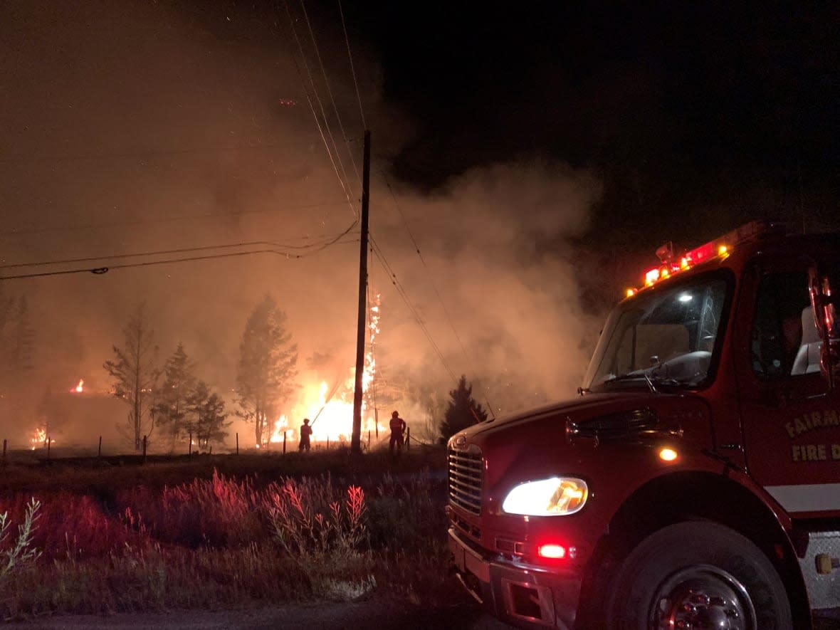 B.C. Wildfire Service crews, local firefighters and RCMP respond to the Hardie Creek fire, south of Fairmont Hot Springs in southeastern B.C., in early August. (B.C. Wildfire Service/Twitter - image credit)