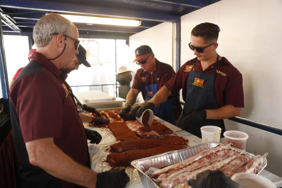 Swine & Dine members prepare and season their ribs on May 19, 2023, during the Memphis in May World Championship Barbecue Cooking Contest at Tom Lee Park in Downtown Memphis. Swine & Dine is competing in the Memphis in May barbecue contest again this year.