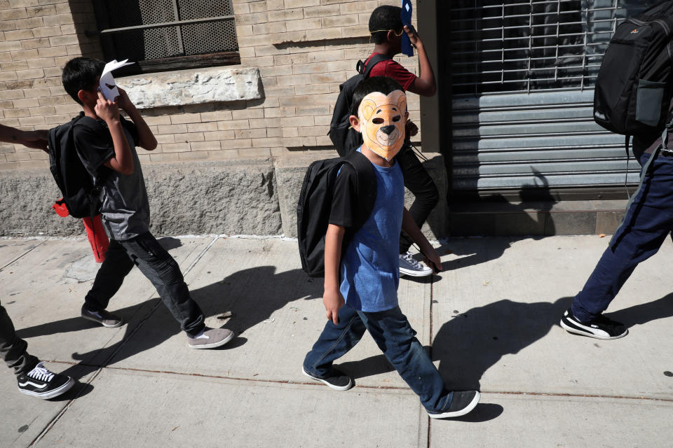 <span class="s1">Children, with their faces covered with masks, leave the Cayuga Center in New York City, which provides foster care and other services to immigrant children separated from their families, on June 21. (Photo: Mike Segar/Reuters)</span>