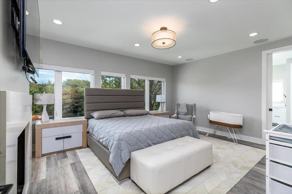 The master bedroom includes a fireplace, walk-in closet with two built-in dressers, a master bath with two vanities and a full tile shower with two shower heads.