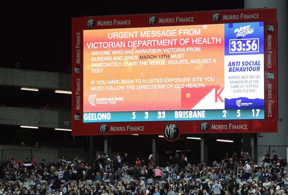 A health warning is put up on the big screen during the round 2 AFL match between the Geelong Cats and the Brisbane Lions at GMHBA Stadium on March 26, 2021 in Geelong, Australia.