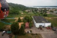 A soccer field is seen atop a building, from a cabin of a cable car traveling over Volga river to Bor, Nizhny Novgorod, Russia July 1, 2018. REUTERS/Damir Sagolj