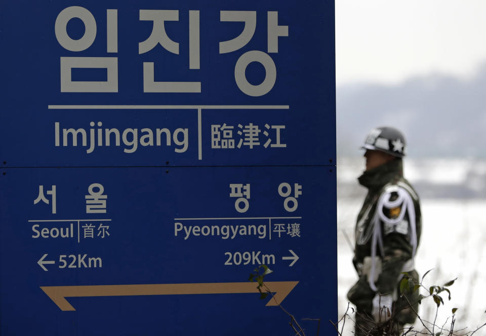 A South Korean soldier stands near a signboard showing the distance to North Korea's capital Pyongyang and to South Korea's capital Seoul from Imjingang Station in Paju, South Korea, Saturday, Nov. 24, 2018. South Korea said Saturday that the United Nations Security Council granted an exemption to sanctions that will allow surveys on North Korean railroad sections the Koreas want to connect with the South. (AP Photo/Lee Jin-man)