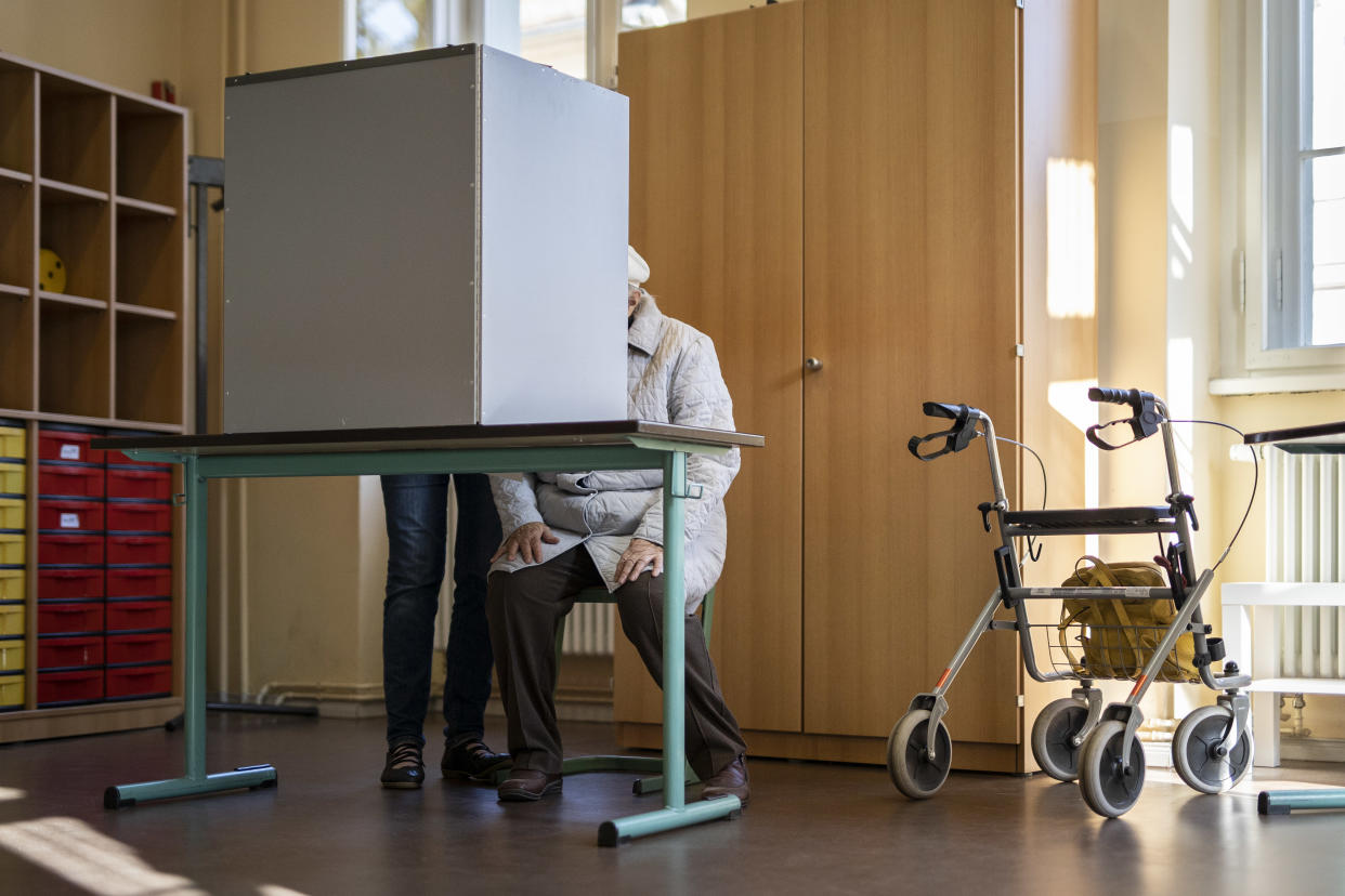 POTSDAM, GERMANY - SEPTEMBER 26: An elder woman is pictured in a poll site for the federal election on September 26, 2021 in Potsdam, Germany. After 16 years chancellorship of Angela Merkel it is going to become a head-on-head between Olaf Scholz (not pictured), chancellor candidate for the SPD, and Armin Laschet (not pictured), prime minister of the German state of North Rhine-Westphalia and Chairman of the CDU. (Photo by Florian Gaertner/Photothek via Getty Images)