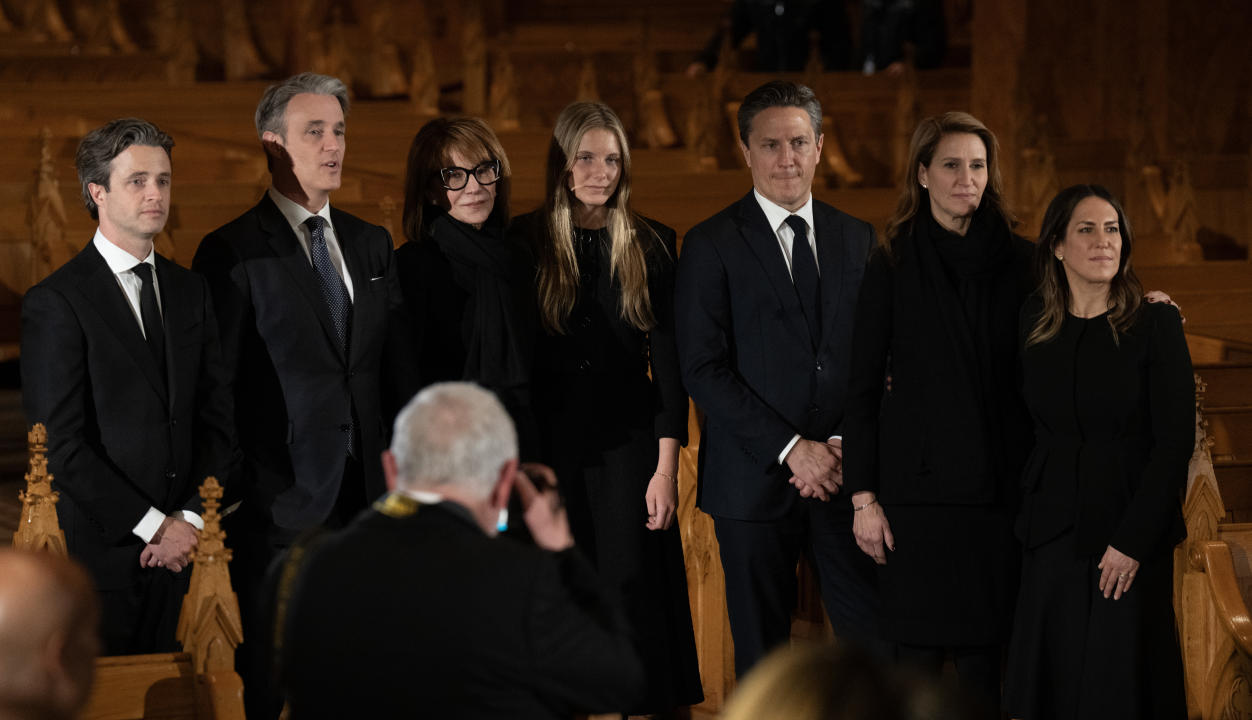 Bill McCarthy, who was photographer to former prime minister Brian Mulroney, takes a photo of the Mulroney family as they watch the last person pay their respects in front of the casket of the former prime minister as he lies in repose, Thursday, March 21, 2024 in Montreal.  THE CANADIAN PRESS/Adrian Wyld