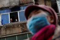 People wear protective masks in an old neighbourhood of Jiujiang