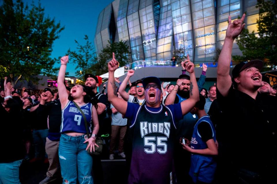 Sacramento Kings fans including Kimberly Del Carmen, left, and Joseph Deleon, center, celebrate in the watch zone in front of Golden 1 Center as the Kings win the first round of the playoffs against the Golden State Warriors on Saturday night.