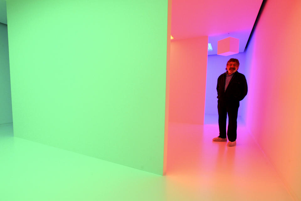 FILE - In this Sept. 10, 2008, file photo, Venezuelan artist Carlos Cruz-Diez poses for a portrait inside his Chromosaturation environment during the press preview in New York. Cruz-Diez, a leading Latin American avant-garde artist praised for his work with color, died Saturday, July 27, 2019, in Paris surrounded by his family, according to his official website. He was 95. (AP Photo/Mary Altaffer, File)