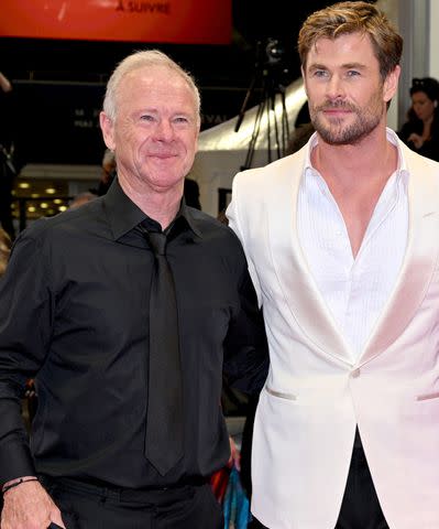 <p>Lionel Hahn/Getty </p> (Left-right:) Craig Hemsworth and Chris Hemsworth on May 15