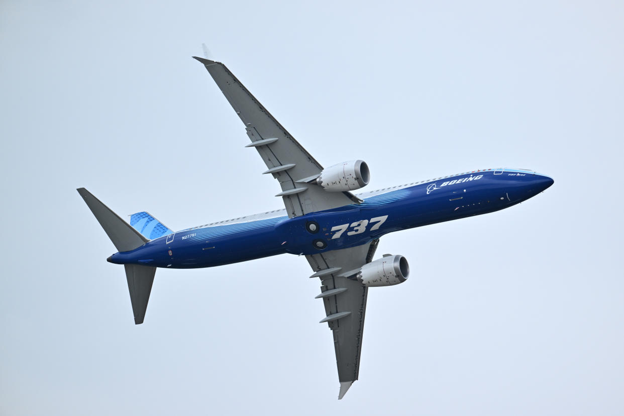 A Boeing 737-10 Max flies through the air.