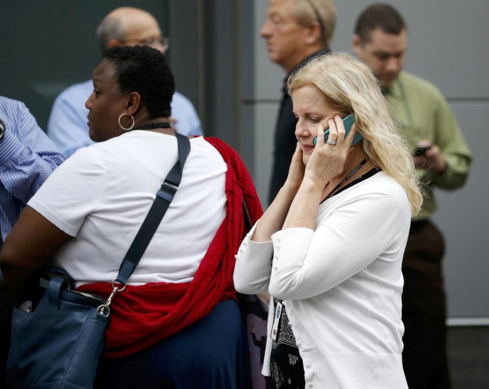 Bystanders look for more information as police respond to reports of a shooting and subsequent lockdown at the U.S. Navy Yard in Washington