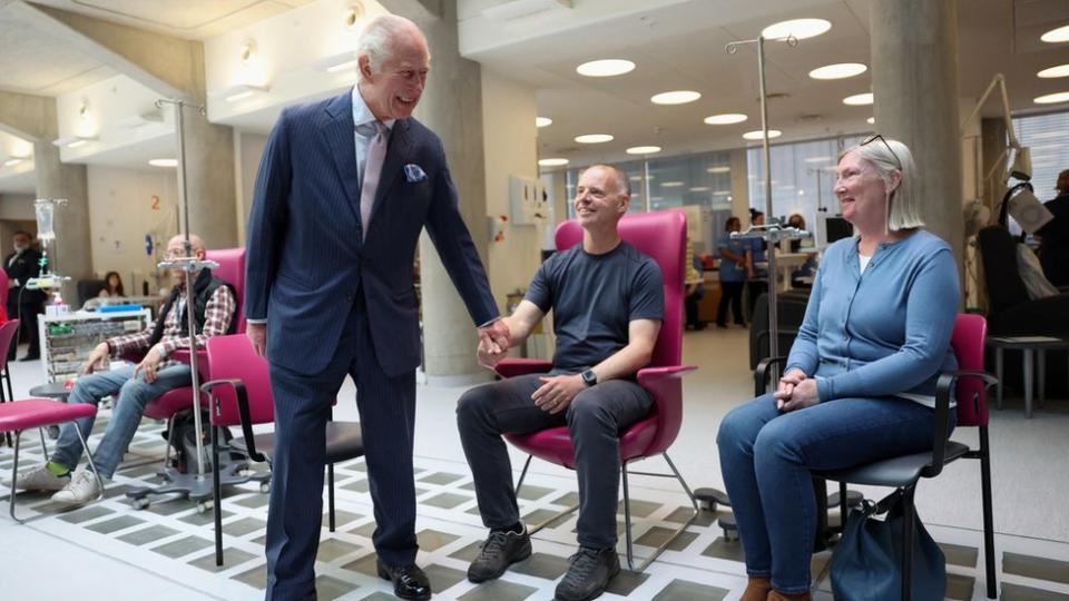 King Charles smiles as he talks to cancer patients in London