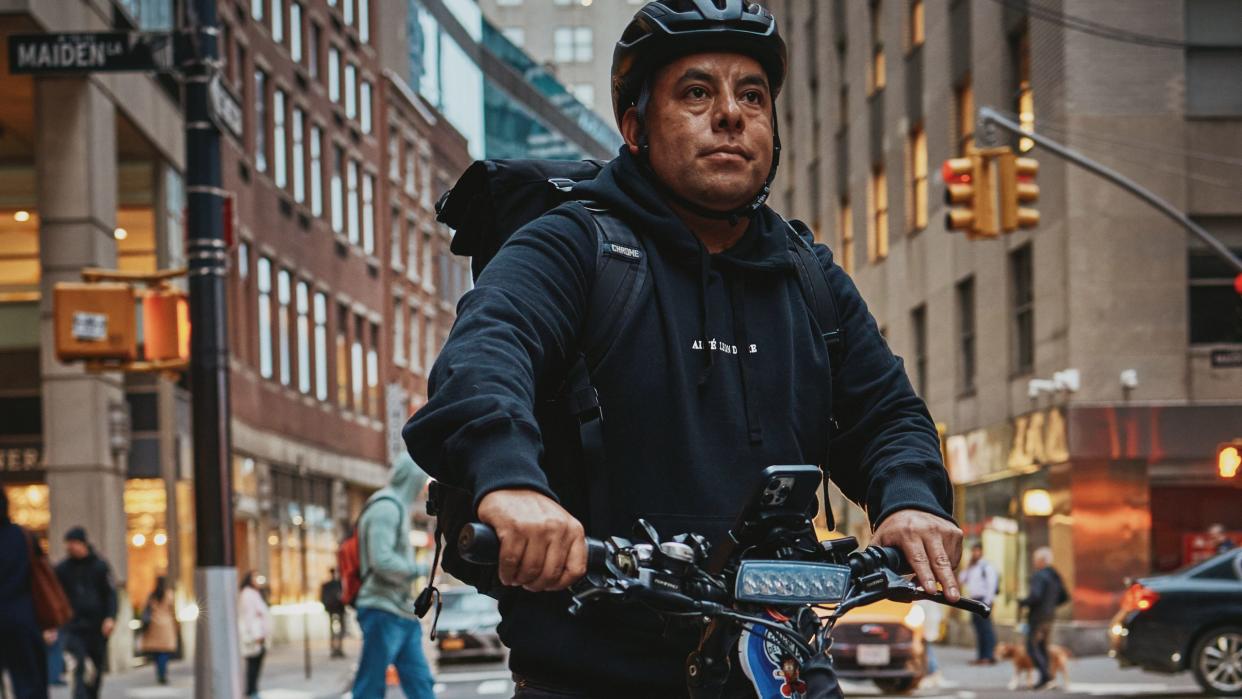 a man poses for a portrait on an ebike in new york city