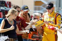 HOMESTEAD, FL - NOVEMBER 19: Kyle Busch, driver of the #18 M&M'sToyota, signs autographs for fans during practice for the NASCAR Sprint Cup Series Ford 400 at Homestead-Miami Speedway on November 19, 2010 in Homestead, Florida. (Photo by Todd Warshaw/Getty Images for NASCAR)