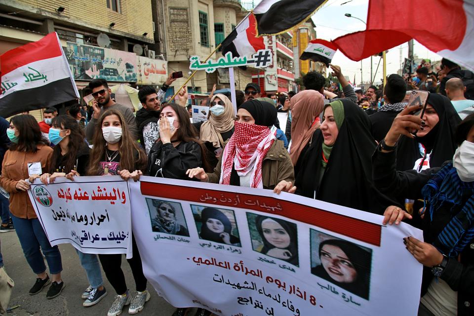 Women hold pictures of female protesters who have been killed in anti-government demonstrations, during a rally in Baghdad, Iraq, Sunday, March 1, 2020. Iraqi student protesters converged on Baghdad's Tahrir Square, the epicenter of the five-month- anti-government protest movement, to voice their rejection of the country's proposed new prime minister. (AP Photo/Khalid Mohammed)