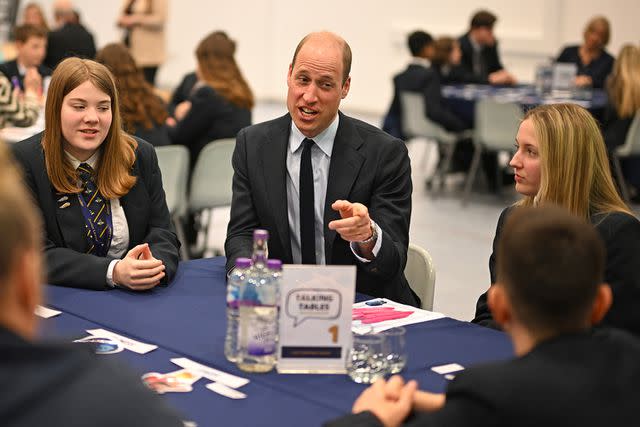 <p>Oli Scarff - WPA Pool/Getty Images</p> Prince William speaks with students at St. Michael's Church of England High School on April 25, 2024