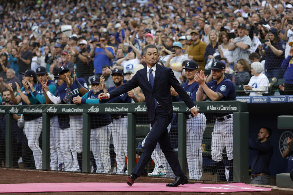 Former Seattle Mariners player Ichiro Suzuki enters the field as he is inducted into the Mariners Hall of Fame during a ceremony before a baseball game between the Mariners and the Cleveland Guardians, Saturday, Aug. 27, 2022, in Seattle. (AP Photo/John Froschauer)