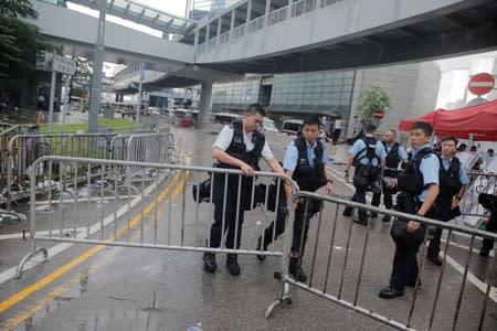 Police close a barrier surrounding the Legislative Council building after violent clashes in Hong Kong