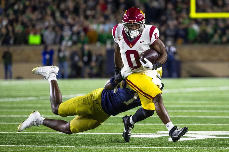 USC running back MarShawn Lloyd tries to pull away from Notre Dame defensive lineman Javontae Jean-Baptiste