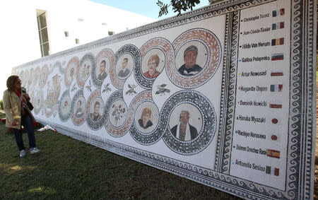 FILE PHOTO: A woman looks at the mosaic portraits of the victims of a militant attack on the Bardo national museum in March 2015 that killed 21 people, at the museum in Tunis, Tunisia March 19, 2016. REUTERS/Zoubeir Souissi/File Photo