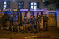 Israeli policemen stand guard at the entrance of a Jewish nationalist religious group's house in the Arab neighborhood of Jaffa, in Tel Aviv, Israel, Saturday, April 24, 2021. Historic Jaffa's rapid gentrification in recent years is coming at the expense of its mostly Arab lower class. With housing prices out of reach, discontent over the city’s rapid transformation into a bastion for Israel’s ultra-wealthy is reaching a boiling point. (AP Photo/Ariel Schalit)