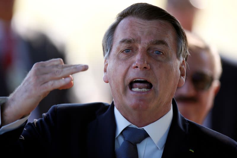 FILE PHOTO: Brazil's President Jair Bolsonaro reacts as he leaves Alvorada Palace, amid the coronavirus disease (COVID-19) outbreak in Brasilia