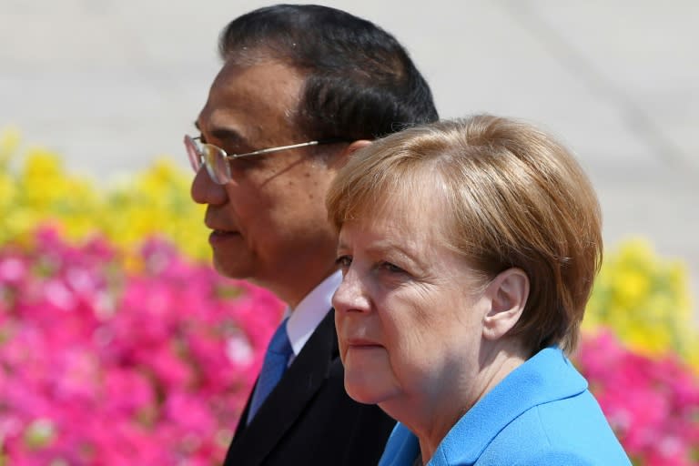 German Chancellor Angela Merkel and Chinese Premier Li Keqiang defended the Iran nuclear deal on Thursday, with Li hinting that terminating the pact would complicate negotiations with North Korea