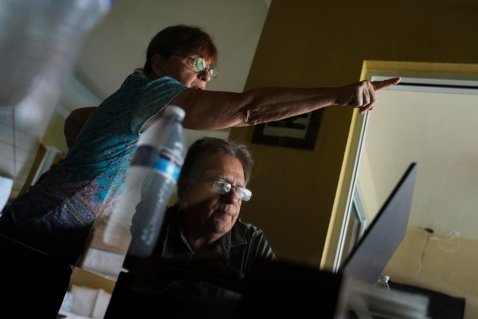 Sue Erario points to the preserved land behind their home at the Royal Palm Golf Estates in Naples on Thursday, Aug. 31, 2023. The land was meant to be protected from future development.