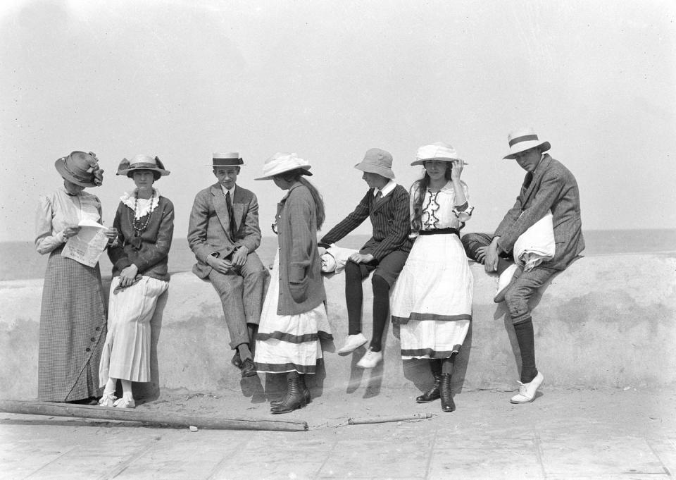 <p>A group of dapper young people enjoy the sunny weather while on a promenade in Calvados, France.</p>