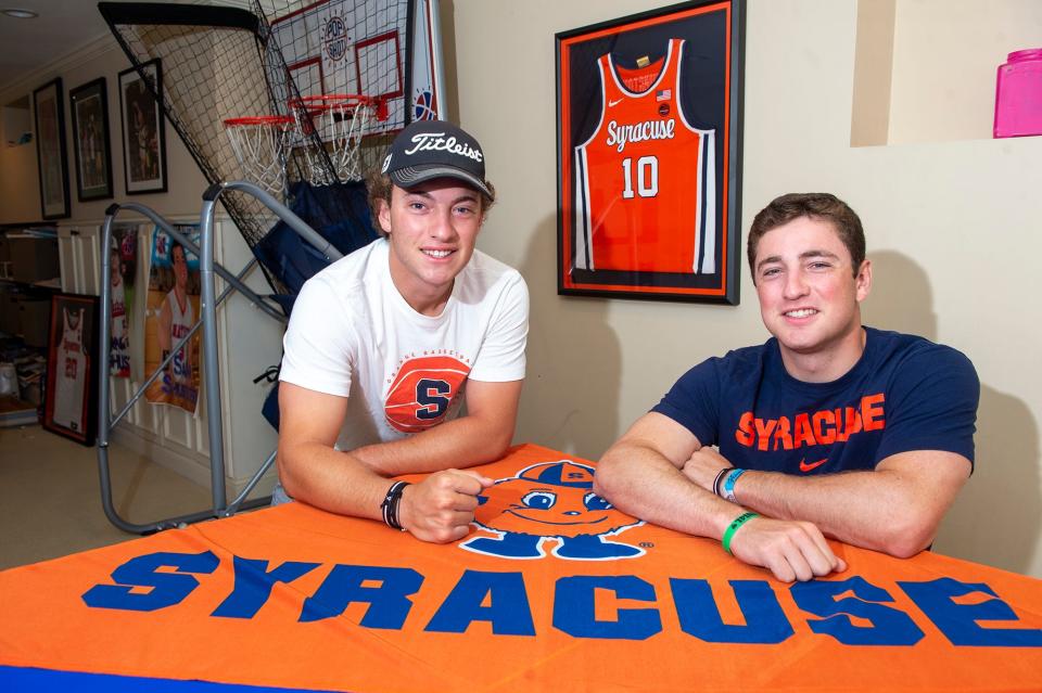 Recent Natick High School graduates Jack and Sam Shuster in their home basement, Aug. 22, 2022.  Both attend Syracuse University.