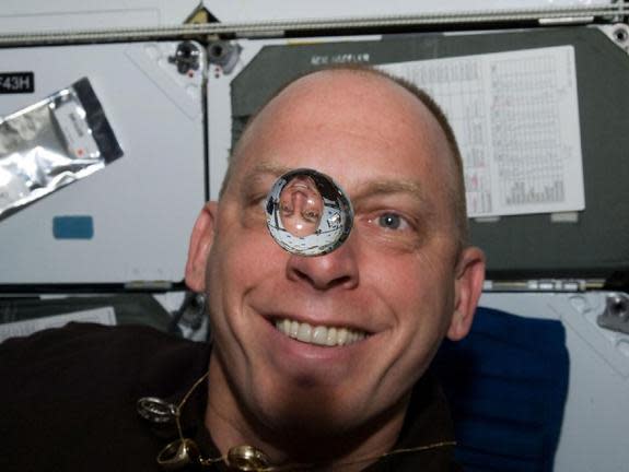 Clayton Anderson amuses himself aboard the space shuttle Discovery during the STS-131 mission in April 2010.