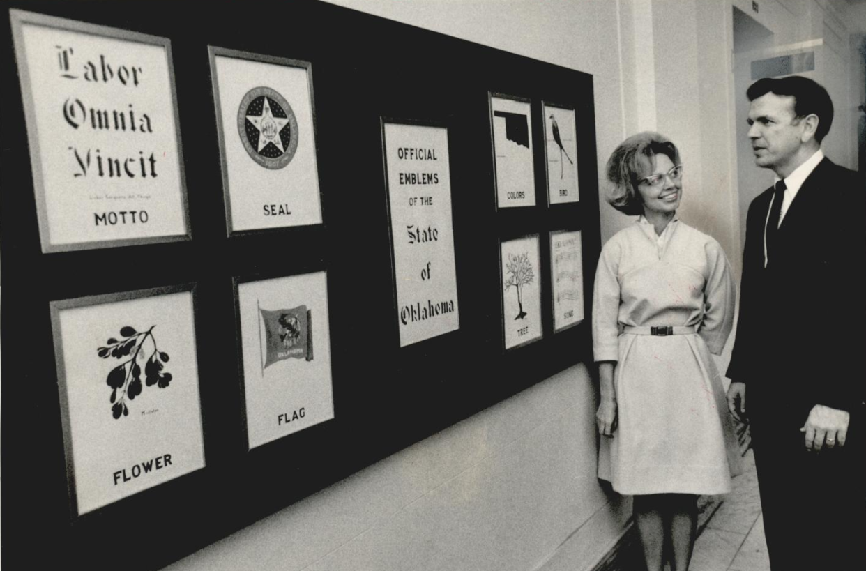 Official state emblems are discussed by Betty Price, the Senate secretary who painted them, and Lt. Gov. George Nigh in a 1968 photo. Price, who served with the Oklahoma Arts Council through the administrations of seven governors, including Nigh, before retiring in 2007, died Oct. 23. She was 92.