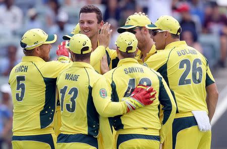 Australia's Josh Hazelwood (C) celebrates with team mates after taking the wicket of India's Shikhar Dhawan for nine runs during the One Day International cricket match in Perth January 12, 2016. REUTERS/Bill Hatto