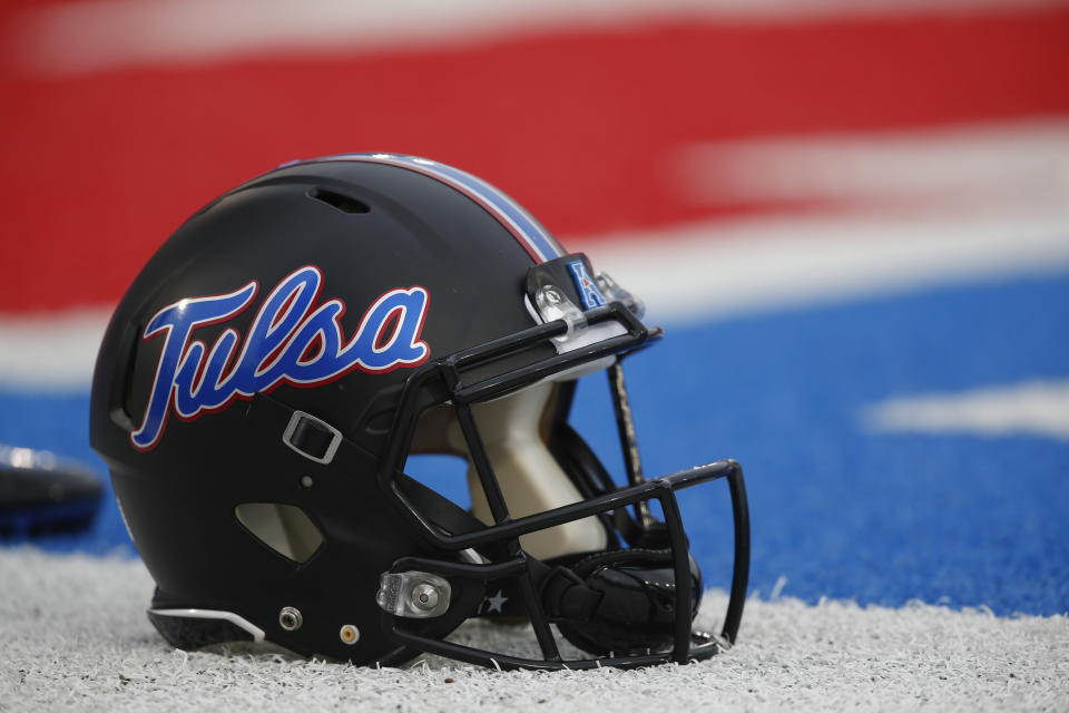 An Tulsa football helmet sits on the sideline before an NCAA football game against SMU, Saturday, Oct. 31, 2015, in Dallas. (AP Photo/Jim Cowsert)