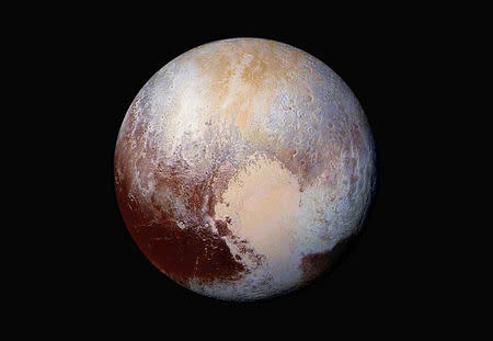 The planet Pluto is pictured in a handout image made up of four images from New Horizons' Long Range Reconnaissance Imager (LORRI) taken in July 2015 combined with color data from the Ralph instrument to create this enhanced color global view. NASA/JHUAPL/SwRI/Handout via REUTERS