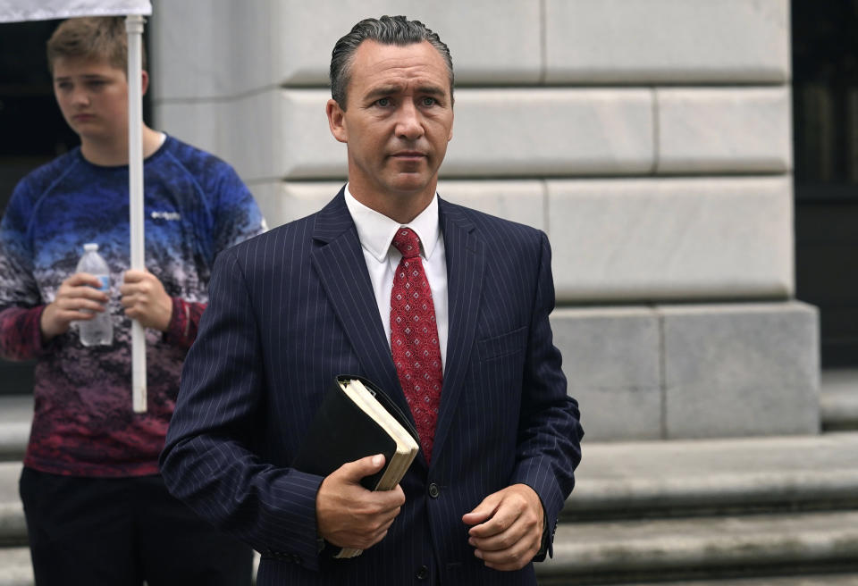 FILE- Tony Spell, pastor of the Life Tabernacle Church of Central City, La., waits with supporters outside the Fifth Circuit Court of Appeals in New Orleans, Monday, June 7, 2021. Louisiana’s Supreme Court announced Tuesday, Dec. 7 that it will hear arguments in the pastor’s fight against criminal charges he faces for violations of pandemic gathering limits that were in effect last year. (AP Photo/Gerald Herbert, File)