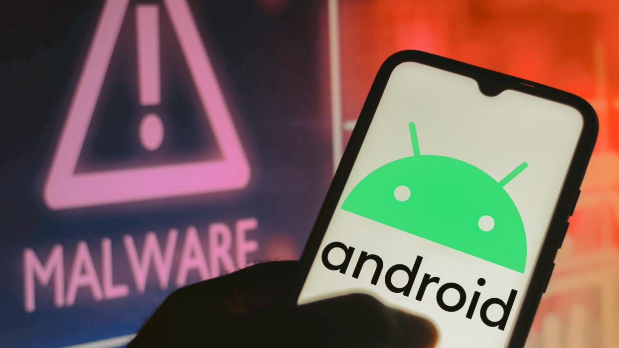  Android logo on phone next to Malware sign. 