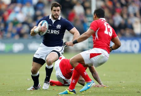 Scotland's Alex Dunbar (L) takes on Tonga's Siale Piutau during their Autumn International rugby union match at Rugby Park Stadium in Kilmarnock, Scotland, November 22, 2014. REUTERS/Russell Cheyne