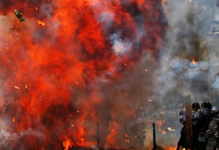 Flames erupt as clashes break out while the Constituent Assembly election is being carried out in Caracas, Venezuela, July 30, 2017. REUTERS/Carlos Garcia Rawlins